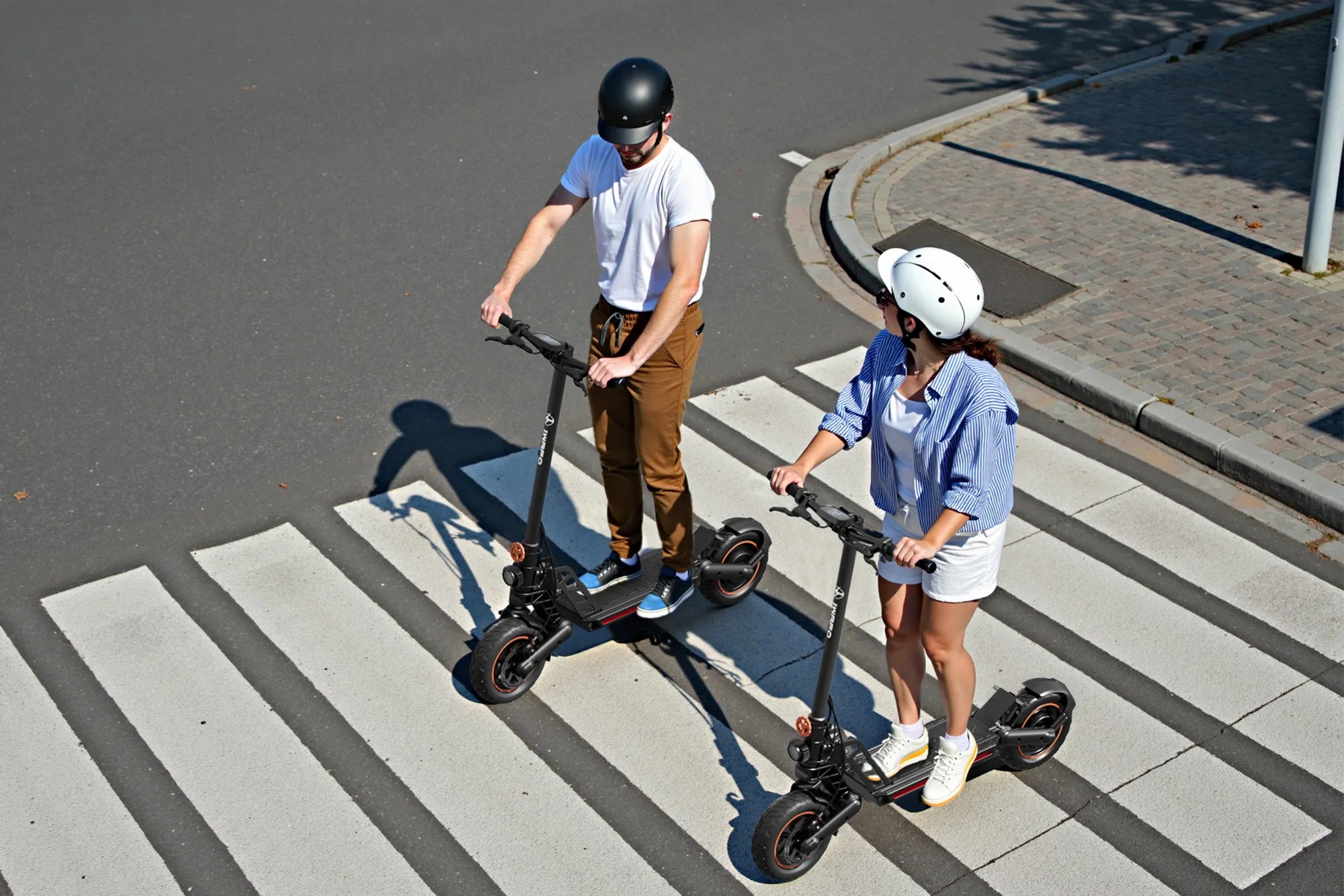 A_man_and_a_woman_are_riding_the_Electric-Scooter-Bike-IWAFO-IS1_across_the_zebra_crossing